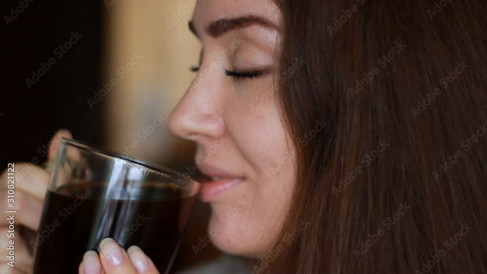 Portrait close up woman with a Cup of coffee and swallowing. Girl drinking hot aroma drink Portrait close up woman with a Cup of coffee and swallowing. Girl drinking hot aroma drink
