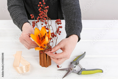Woman shows how to make modern, minimalistic floral decoration