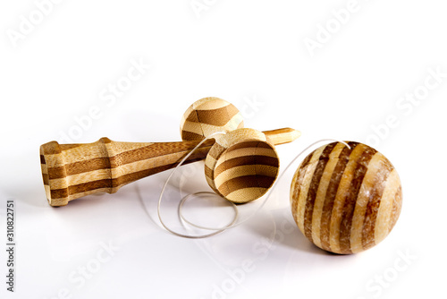 Kendama japanese wooden toy on isolated on white. used kendama with scratches and dents on the ball.