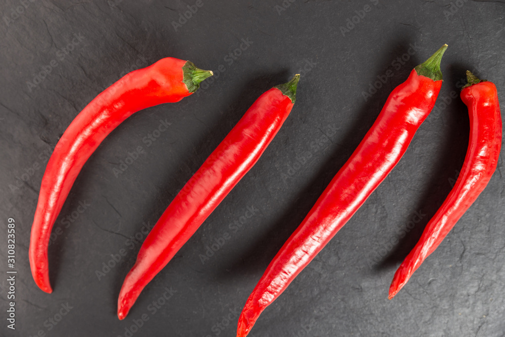 red chili peppers on a black chopping Board