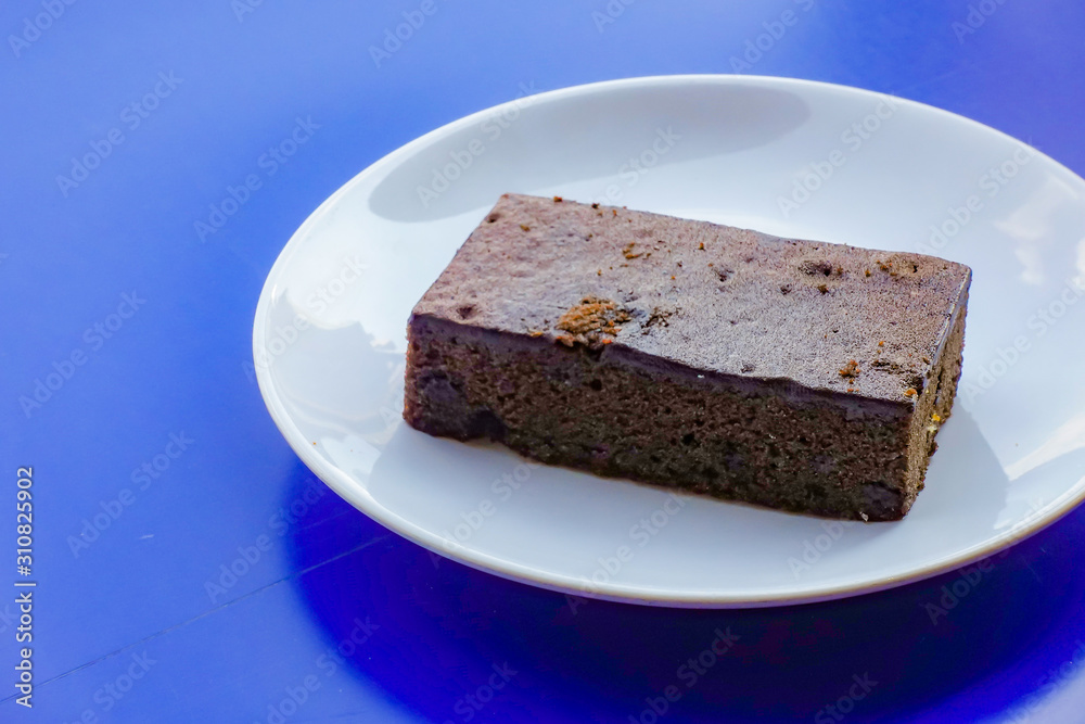 Delicious dark chocolate fudge on white plate Delicious dark chocolate fudge on white plate