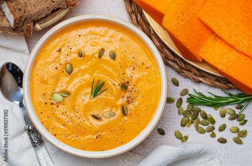 Delicious pumpkin cream. Home and rustic appearance. Includes fresh pumpkin, seeds and rye bread. Aerial view.