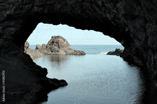 A rock cave with a natural pool near the Atlantic Ocean (Madeira, Portugal, Europe)
