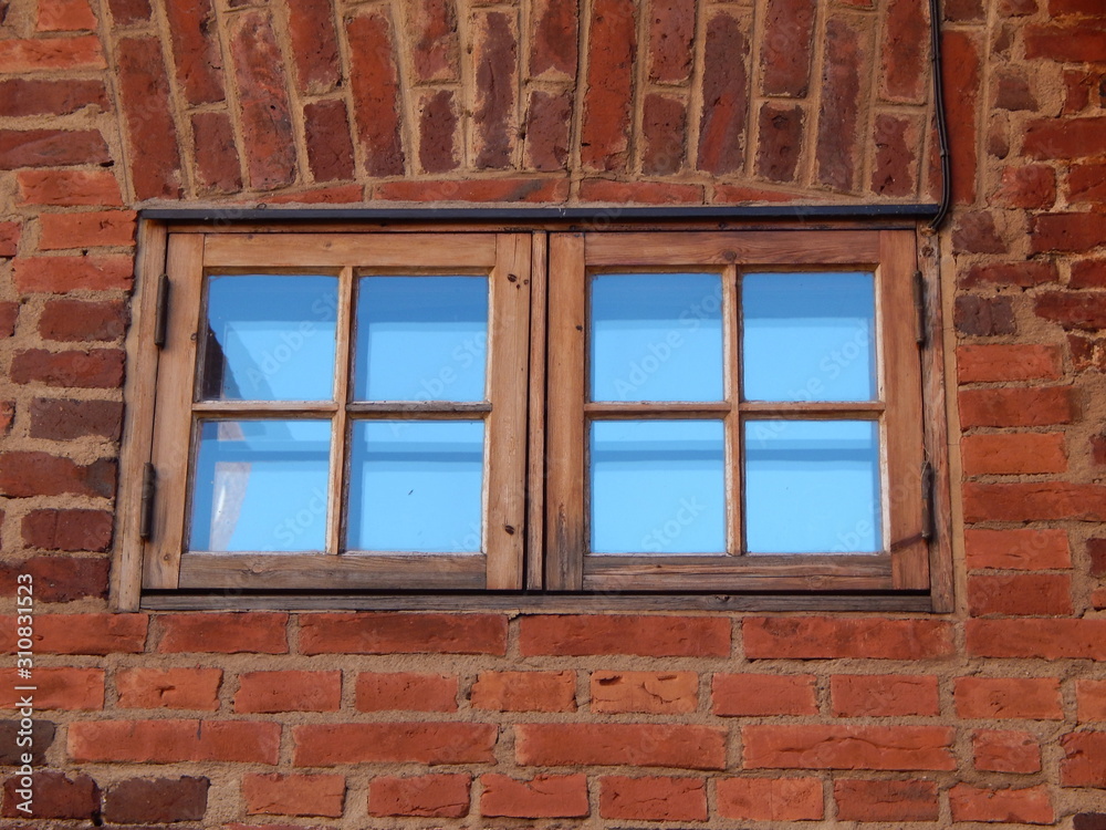 Red brick old wall and two windows in it Red brick old wall and two windows in it