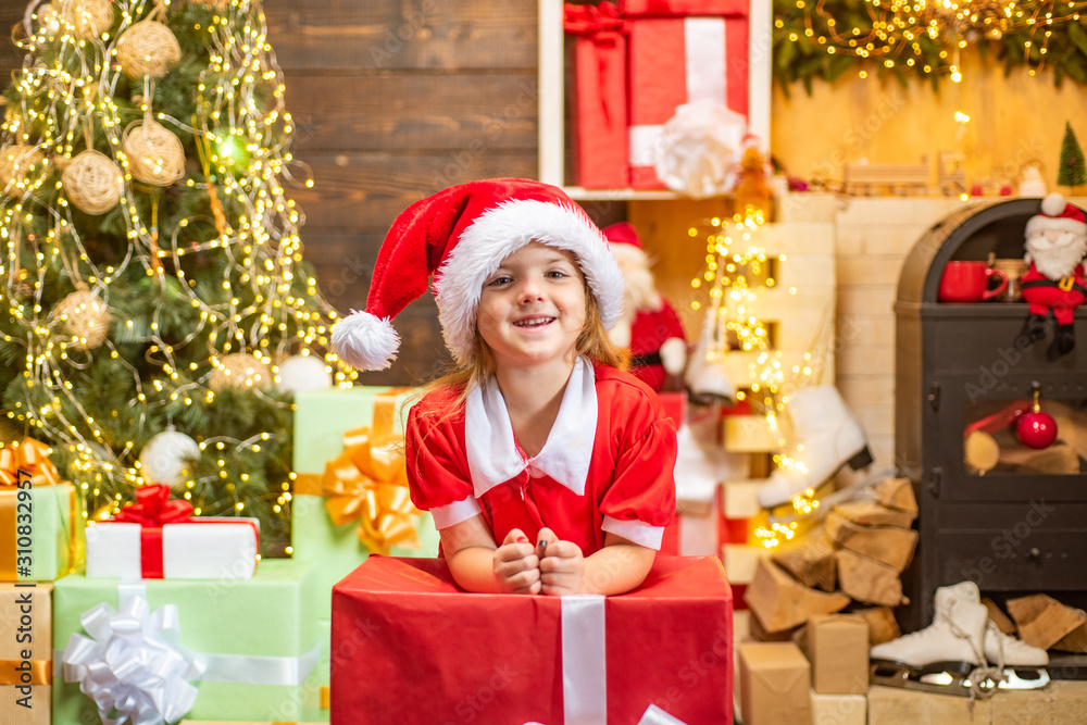 Cute little kids celebrating Christmas. Christmas Celebration holiday. Happy cute child in Santa hat with present have a Christmas. Little Santa Claus gifting gift. Cute little kids celebrating Christmas. Christmas Celebration holiday. Happy cute child in Santa hat with present have a Christmas. Little Santa Claus gifting gift.