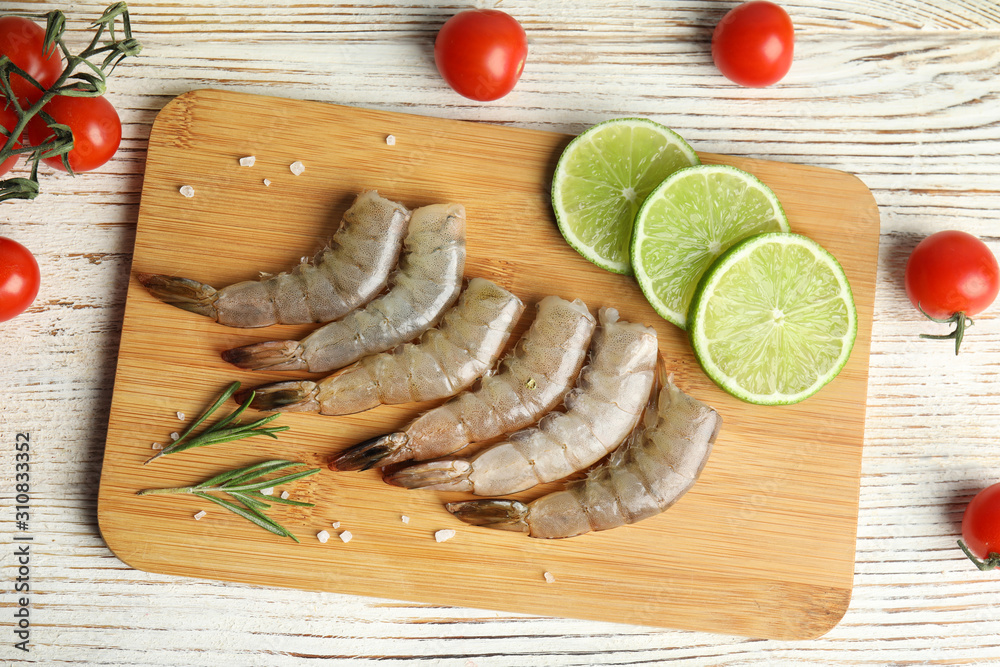 Flat lay composition with fresh raw shrimps on white wooden table Flat lay composition with fresh raw shrimps on white wooden table