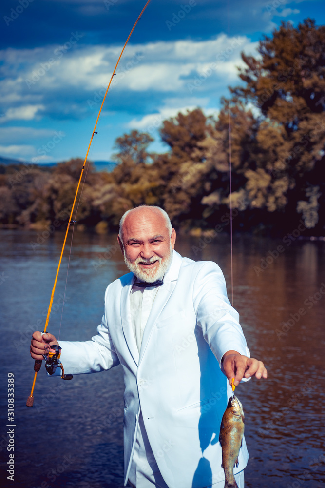 Cheerful Adult Fisherman Standing Angling Rod Stock Photo