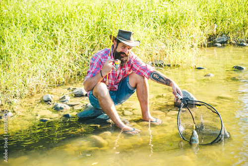 Bearded man. Hobby and recreation. Fishing freshwater lake pond river. Rural getaway. Pothunter. Catching and fishing. Fishermen fishing equipment. photo