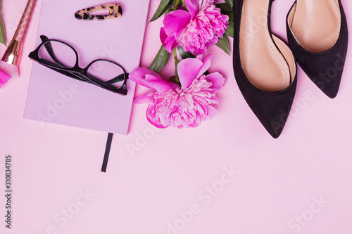 Creative composition with woman's accessories and beautiful pink peonies