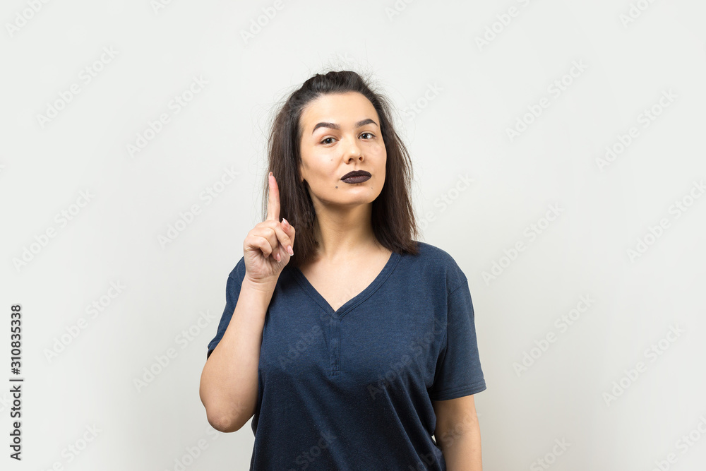 Image of excited young lady with glasses. Looking camera have an idea. Stands on a white background. Image of excited young lady with glasses. Looking camera have an idea. Stands on a white background.
