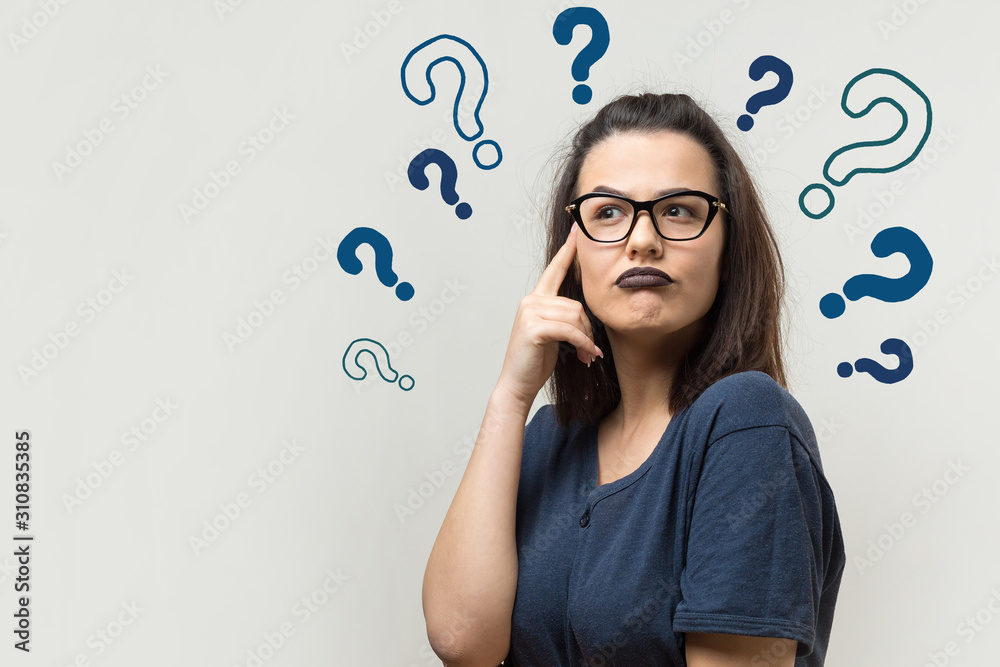 Image of excited young lady with glasses. Looking camera have an idea. Stands on a white background. Image of excited young lady with glasses. Looking camera have an idea. Stands on a white background.