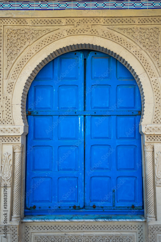 Closeup view of old blue vintage door. Vertical color photography.
