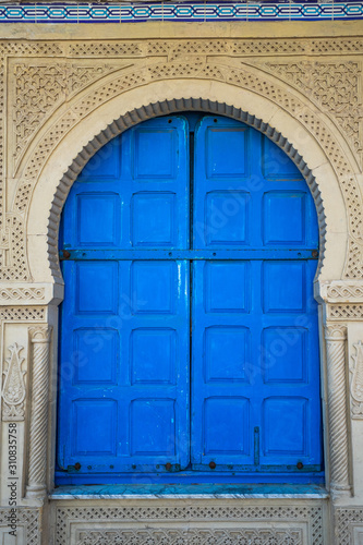 Closeup view of old blue vintage door. Vertical color photography. © Andrii Oleksiienko
