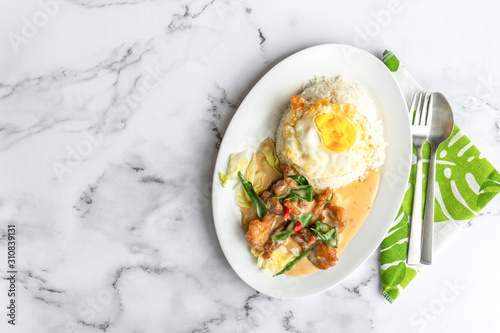 Creamy salted egg fried chicken with rice & egg. Asian food on table. Flat lay top down view.