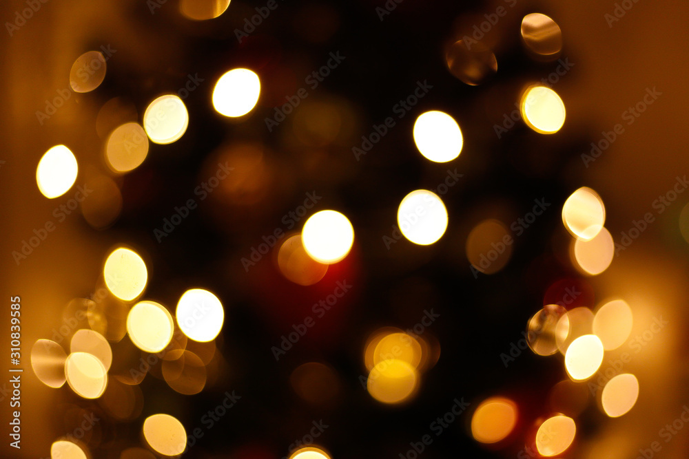 Lights of the christmas tree in the city in blur. Bokeh background concept. New year lights defocused. 
