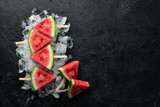 summer watermelon slice popsicles on ice. Top view. Free copy space.