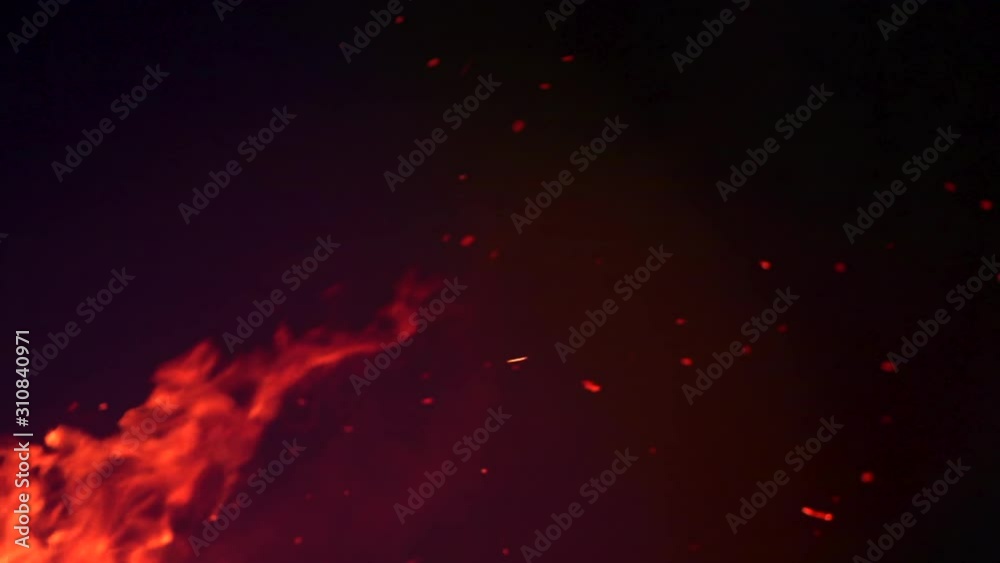 Fire flames with flying sparks background. Firestorm texture, shot of flying fire sparks in the air. Burning bonfire over dark night backdrop. Slow motion 4K UHD Fire flames with flying sparks background. Firestorm texture, shot of flying fire sparks in the air. Burning bonfire over dark night backdrop. Slow motion 4K UHD