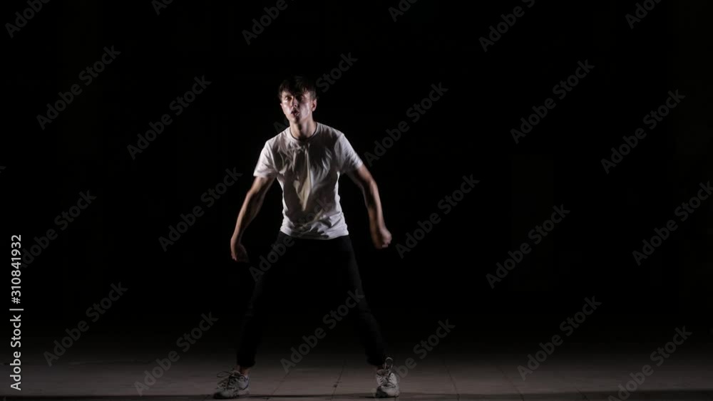 young dancer dancing break dance, hip hop, street dance in the studio on a black background, isolated young dancer dancing break dance, hip hop, street dance in the studio on a black background, isolated