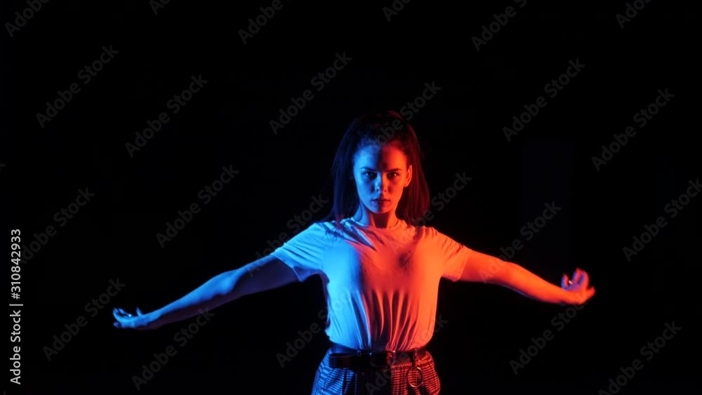 young beautiful girl dancing vogue, street dancing in the studio on a black background, isolated young beautiful girl dancing vogue, street dancing in the studio on a black background, isolated