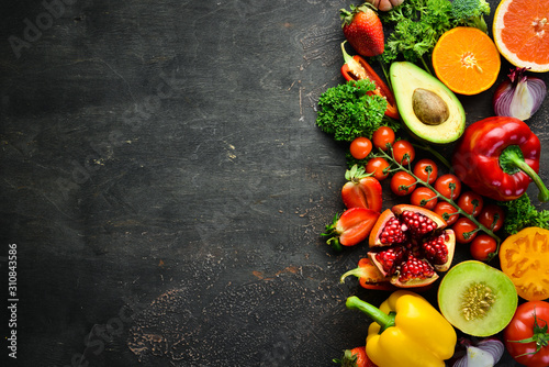Fototapeta Naklejka Na Ścianę i Meble -  Fresh fruits, vegetables and berries. On a black background. Banner Top view. Free space for your text.