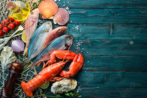 Seafood on stone background. Lobster, fish, shellfish. Top view. Free copy space.