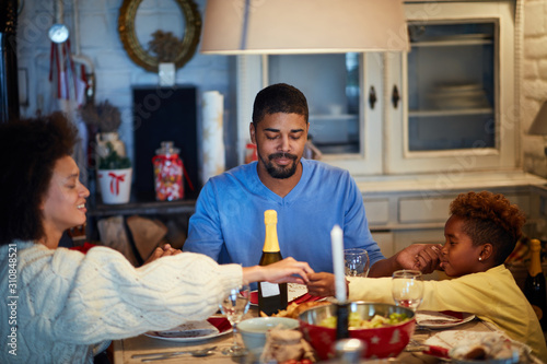 People having Christmas prayer for dinner at home