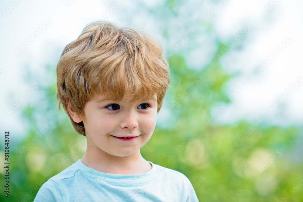 Emotional kid walks outdoors and enjoy walking. While having fun outdoors. Portrait of a boy smiling. Emotional kid. Emotions on the face. Child play outdoors. Child outdoors in nature. Funny boy. Emotional kid walks outdoors and enjoy walking. While having fun outdoors. Portrait of a boy smiling. Emotional kid. Emotions on the face. Child play outdoors. Child outdoors in nature. Funny boy.