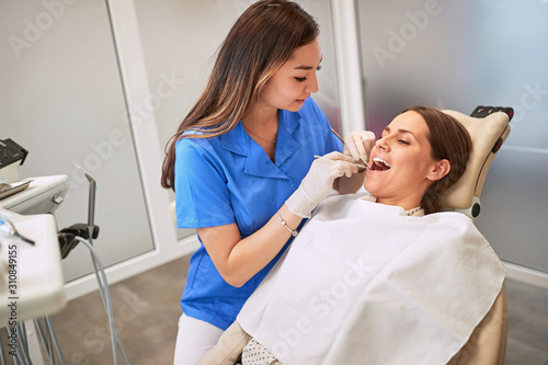 Dentist treating woman in dental chair