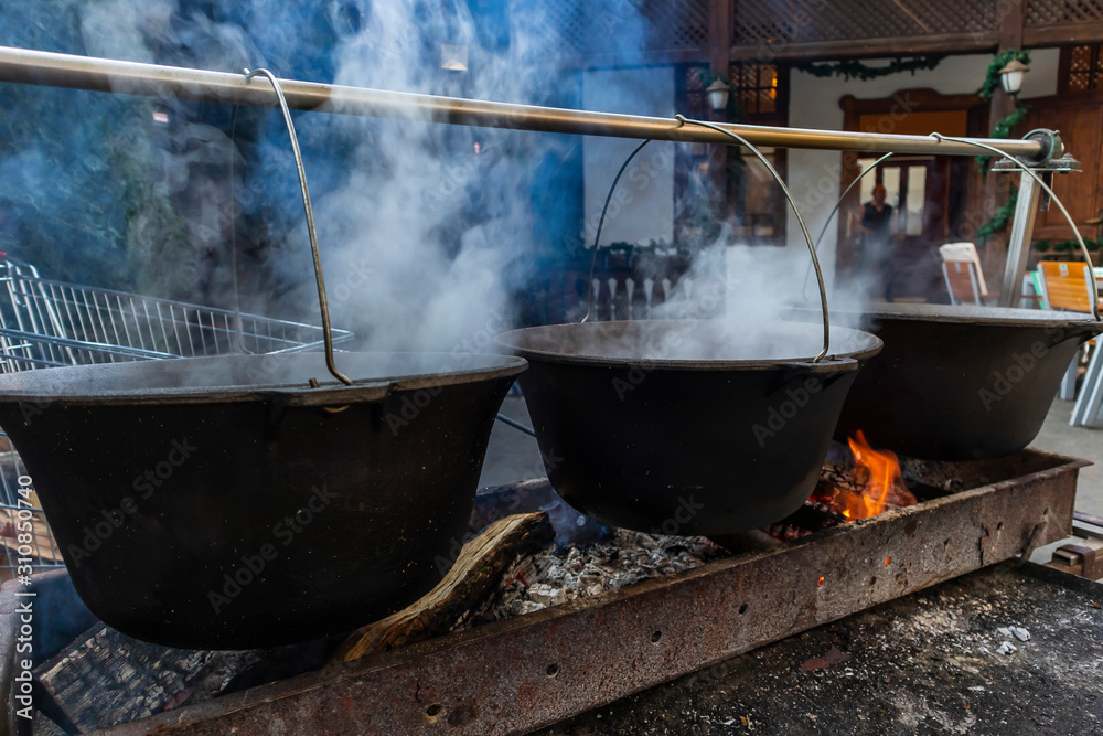 Traditional cooking in a pot over campfire Traditional cooking in a pot over campfire