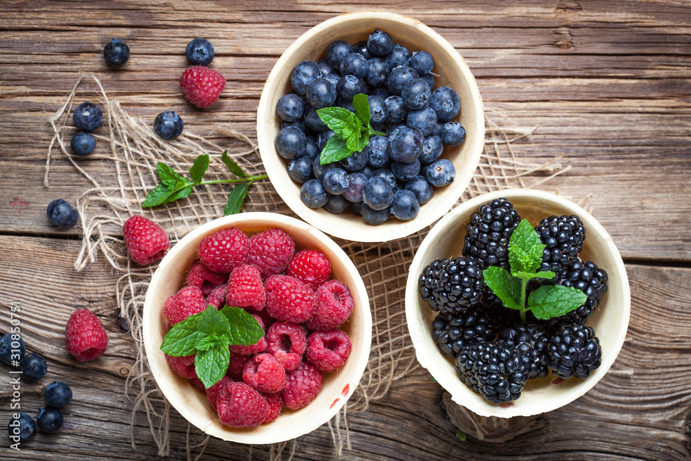 Blackberries, raspberries and blueberries in a waffle bowls. Blackberries, raspberries and blueberries in a waffle bowls.
