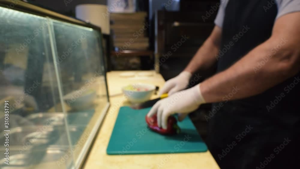 A Professional Chef Nicely Slicing The Red Pepper - Tilt Down Shot A Professional Chef Nicely Slicing The Red Pepper - Tilt Down Shot