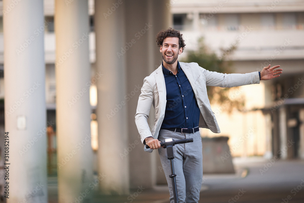 Businessman driving electric scooter in the city