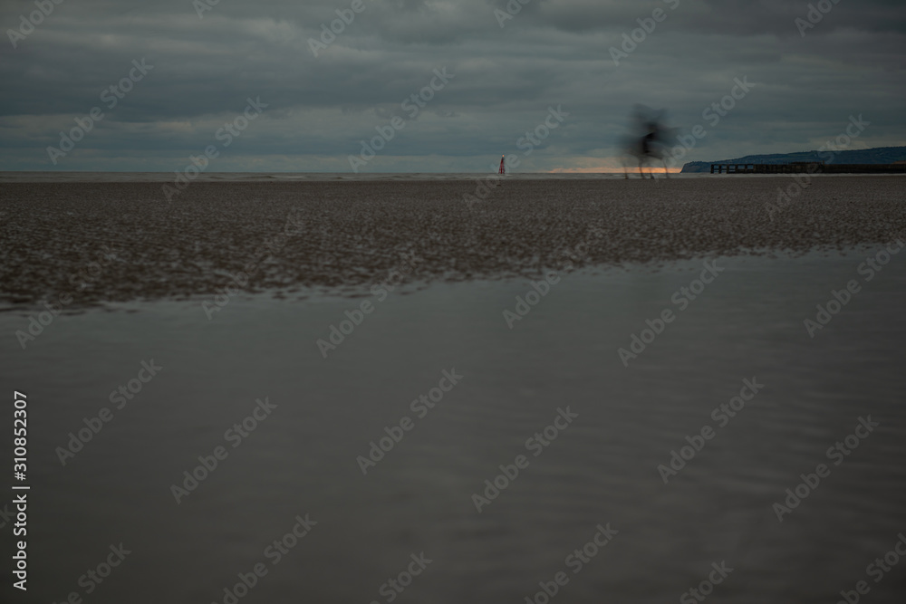 Horse ridden on bleak dramatic Camber Sands beach