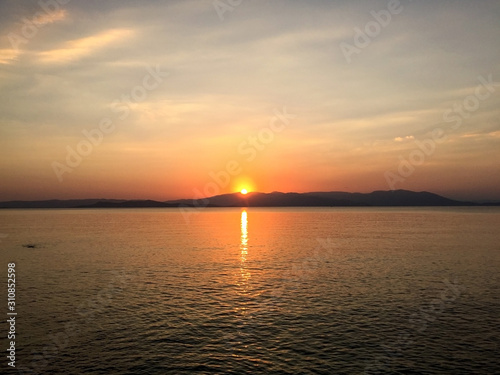 Beautiful sunset on Santorini island, Greece. Famous travel destination. Summer landscape, sea view