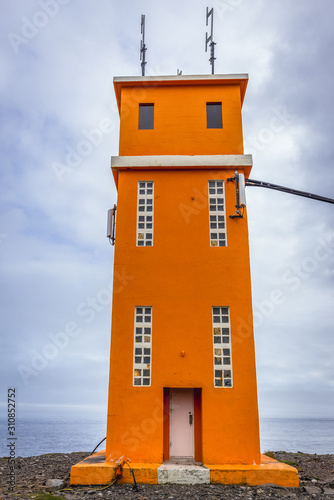 Orange building of Hvalnes Lighthouse located on Hvalnes peninsula in Iceland