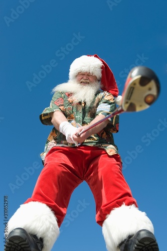 Santa Claus With Golf Club Against Sky