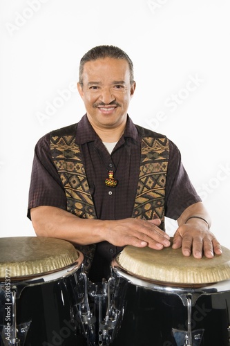 Happy Senior Artist Playing Drums