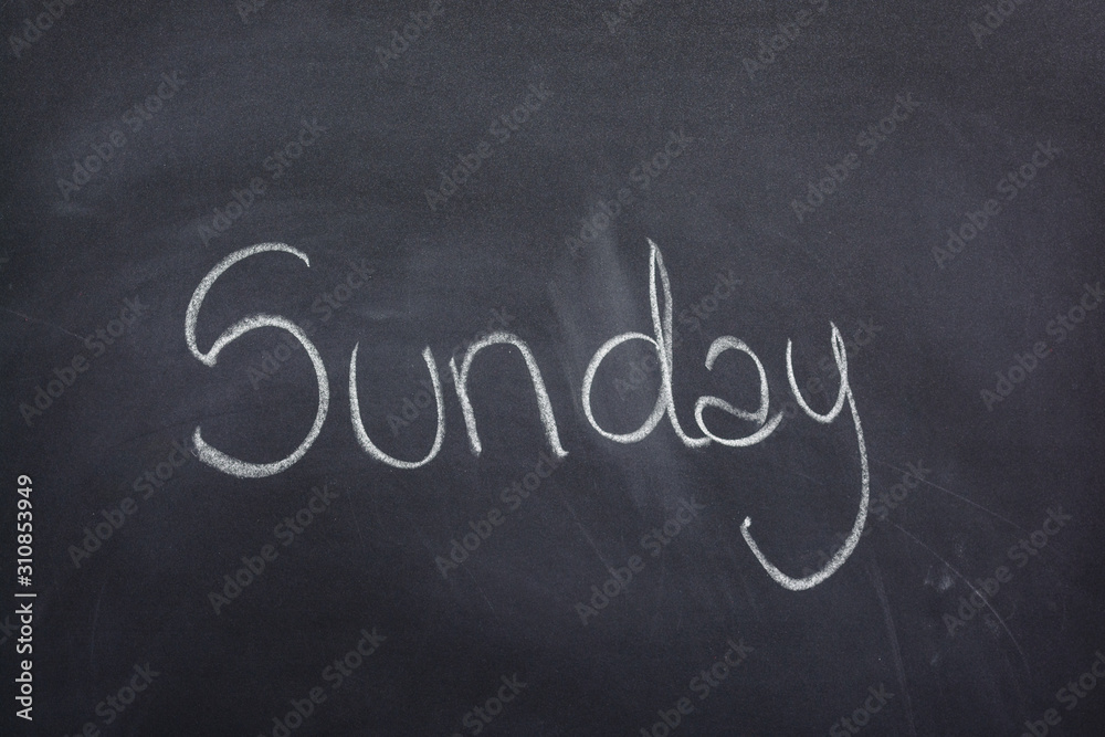 Obraz premium Day of the week written on a blackboard with white chalk, sunday