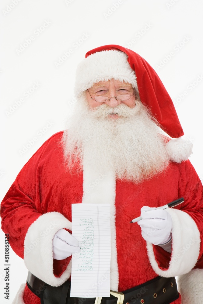 Naklejka premium Santa Claus Standing With Paper And Pen