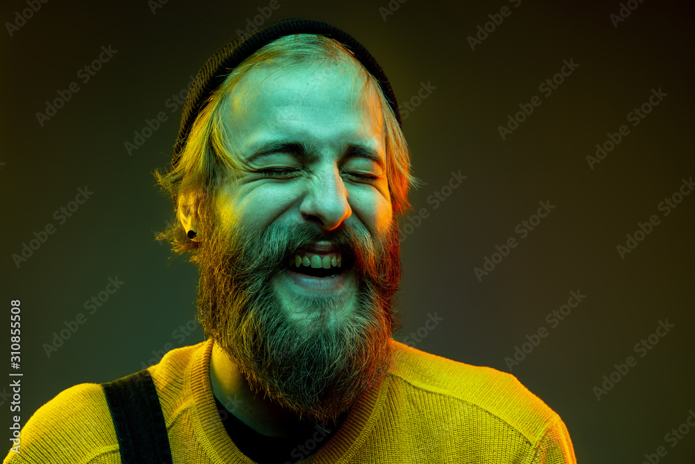 Caucasian woman's portrait isolated on gradient studio background in neon light. Beautiful male model with hipster style. Concept of human emotions, facial expression, sales, ad. Crazy happy laughting Caucasian woman's portrait isolated on gradient studio background in neon light. Beautiful male model with hipster style. Concept of human emotions, facial expression, sales, ad. Crazy happy laughting