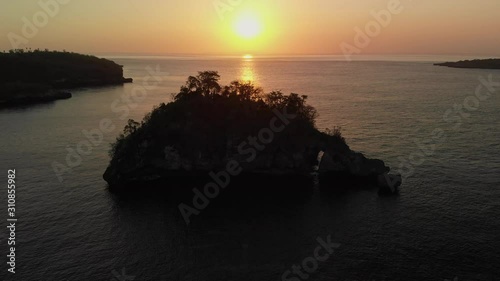 Rock in Crystal Bay at sunset , Nusa Penida island, Indonesia photo