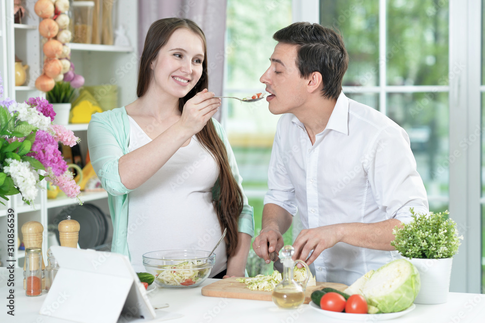 Close up portrait of happy husband and wife cooking together in the kitchen Close up portrait of happy husband and wife cooking together in the kitchen