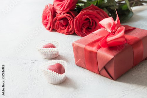 Valentines day greeting card with romantic gift, red roses, sweets on white. Space for text.