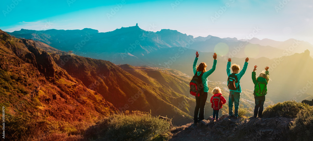 happy family travel in mountains at sunset, panorama - obrazy, fototapety, plakaty 