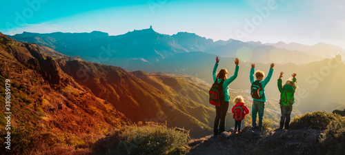 happy family travel in mountains at sunset, panorama