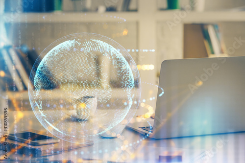 Multi exposure of table with computer and world map hologram. International data network concept.