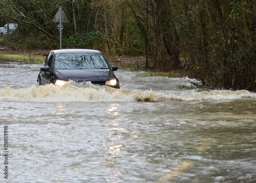 Horley,Surrey/United Kingdom- December 29 2019: The river Mole has flooded its banks, cars are trying to drive through the flood waters