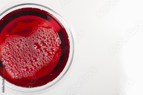 Glass of red wine with shadow.Top view. Abstract red wine bubbles.