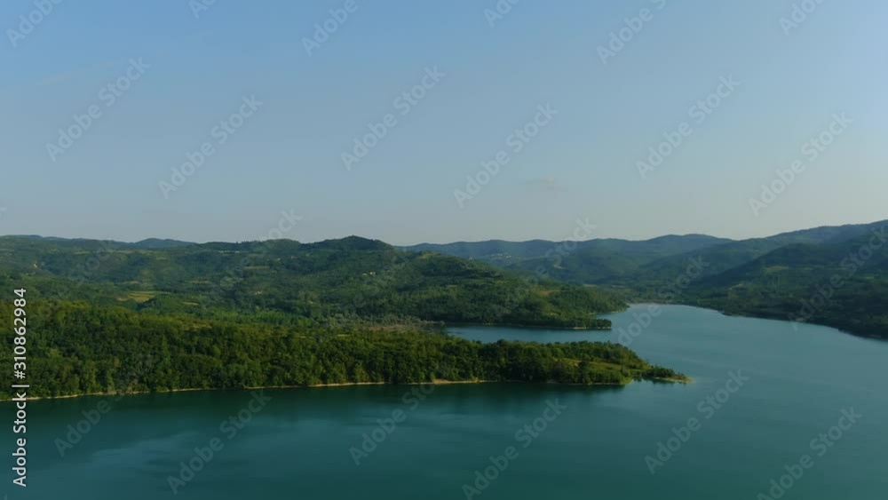 Lake Butoniga water reservoir dam in Croatia pan left panorama, Aerial drone left reveal shot