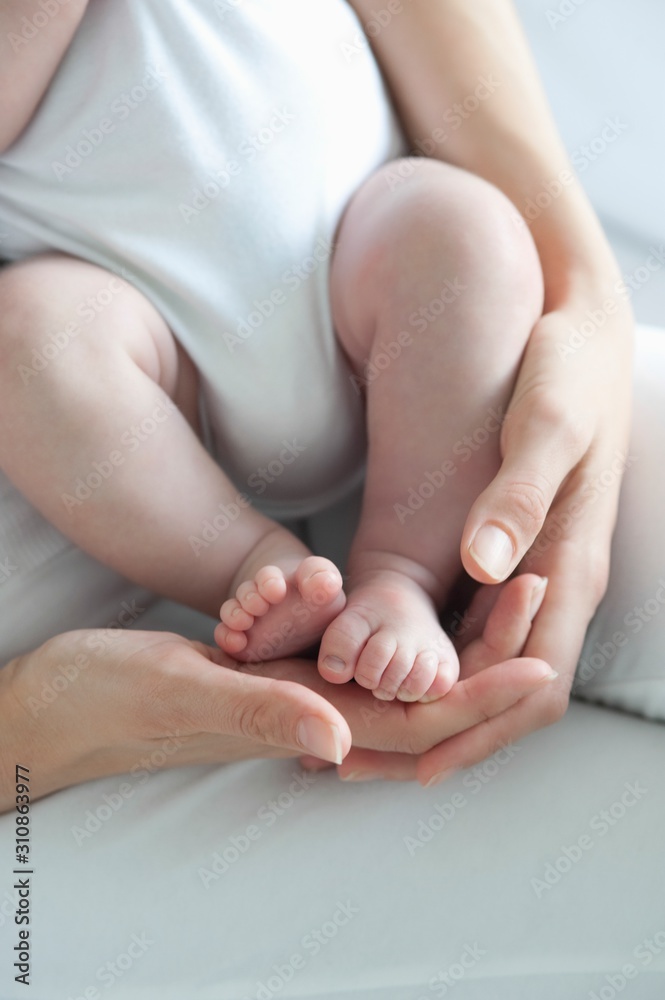 Mother Holding Baby Boy's Feet - obrazy, fototapety, plakaty 
